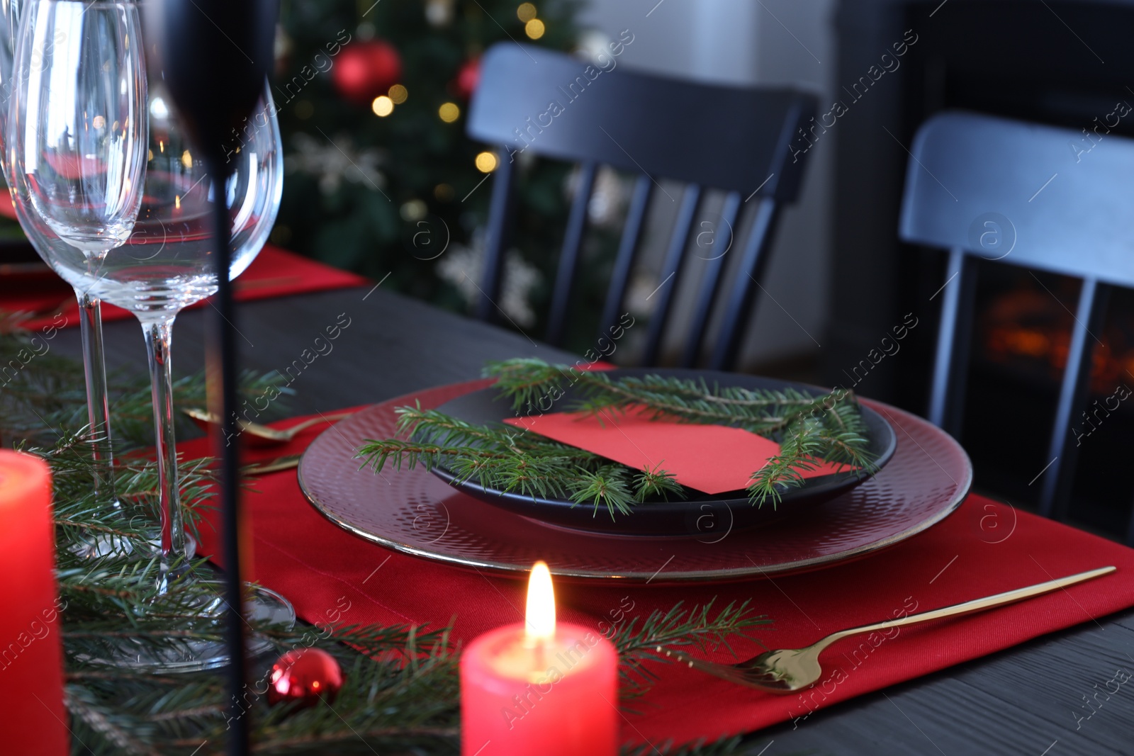 Photo of Elegant Christmas place setting with blank card and festive decor on table, closeup