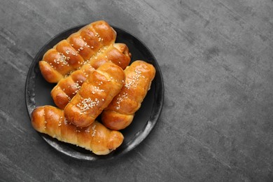 Photo of Delicious sausage rolls on grey table, top view. Space for text