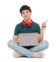 Photo of Portrait of student with laptop and headphones sitting on white background