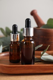 Photo of Aromatherapy. Bottles of essential oil on brown table, closeup