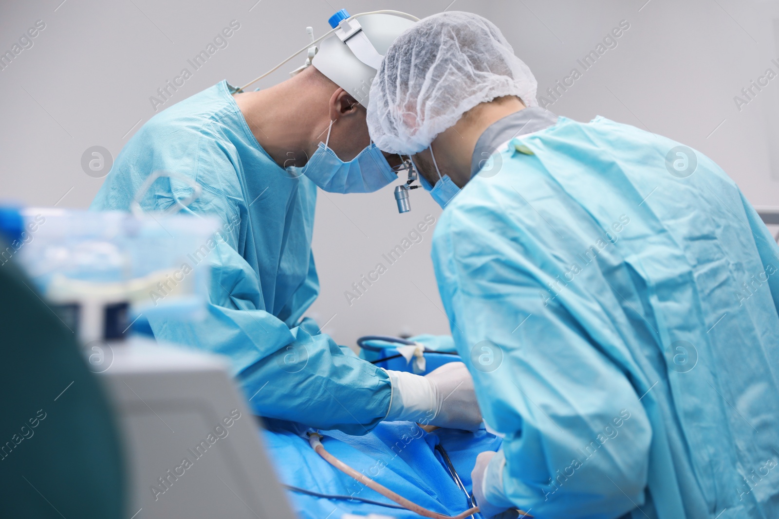 Photo of Team of professional doctors performing operation in surgery room