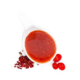 Photo of Chili sauce in spoon isolated on white, top view