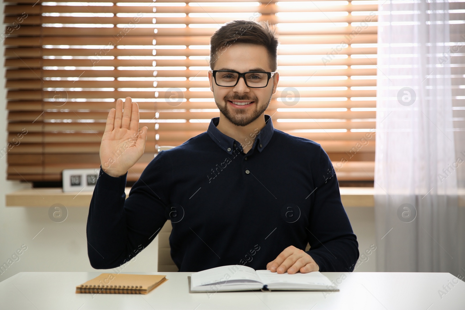 Photo of Happy man using video chat in modern office, view from web camera