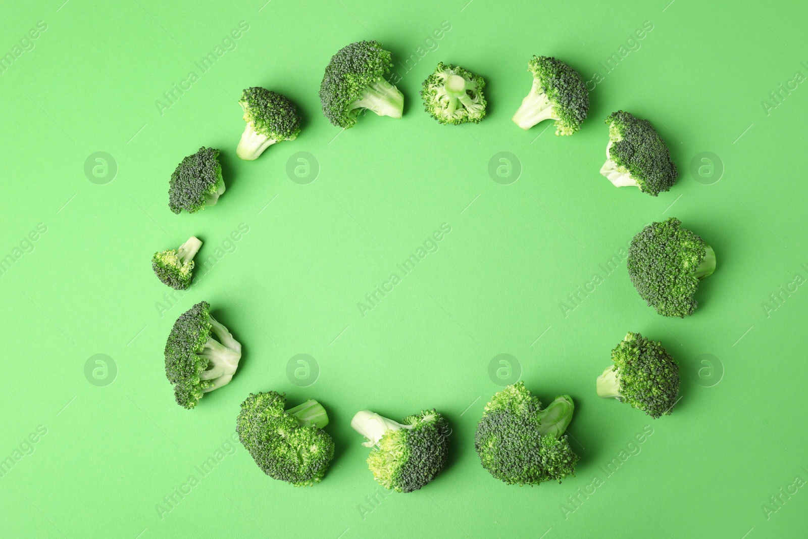 Photo of Flat lay composition with fresh green broccoli on color background. Space for text