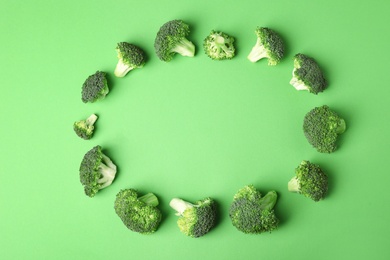 Photo of Flat lay composition with fresh green broccoli on color background. Space for text