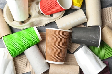 Pile of cardboard garbage on grey background, top view. Recycling problem