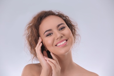 Photo of Beautiful young woman with acne problem on light background