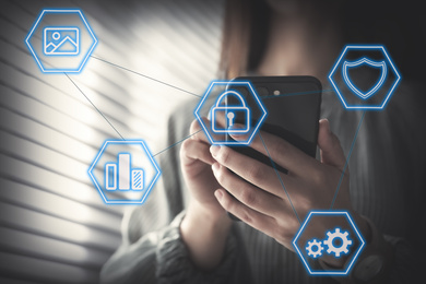 Image of Information security. Young woman using smartphone indoors, closeup