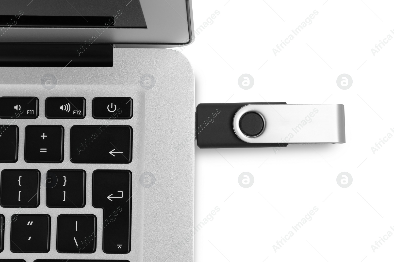 Photo of Modern usb flash drive attached into laptop on white background, top view