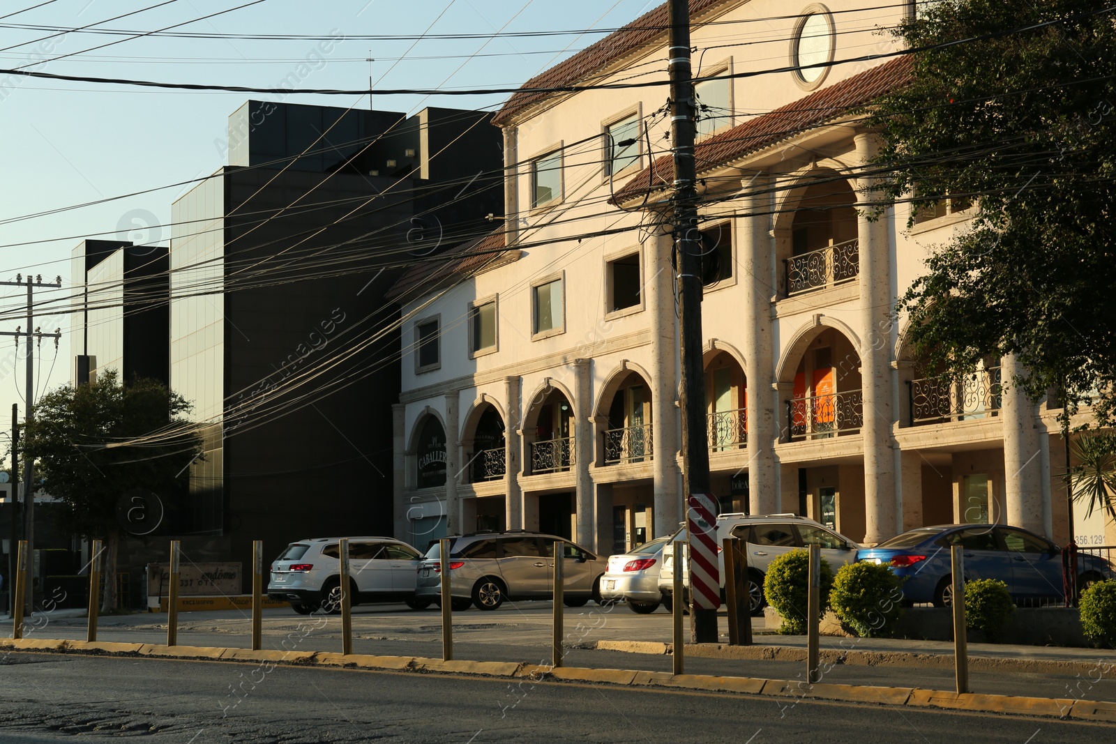 Photo of Many parked cars near building on sunny day