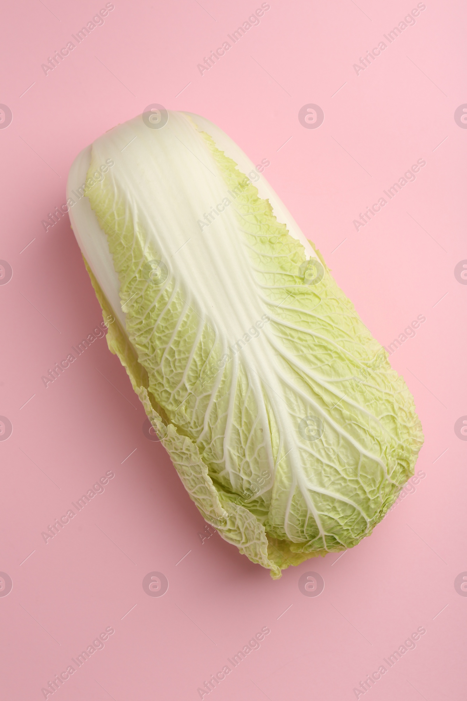 Photo of Fresh ripe Chinese cabbage on pink background, top view