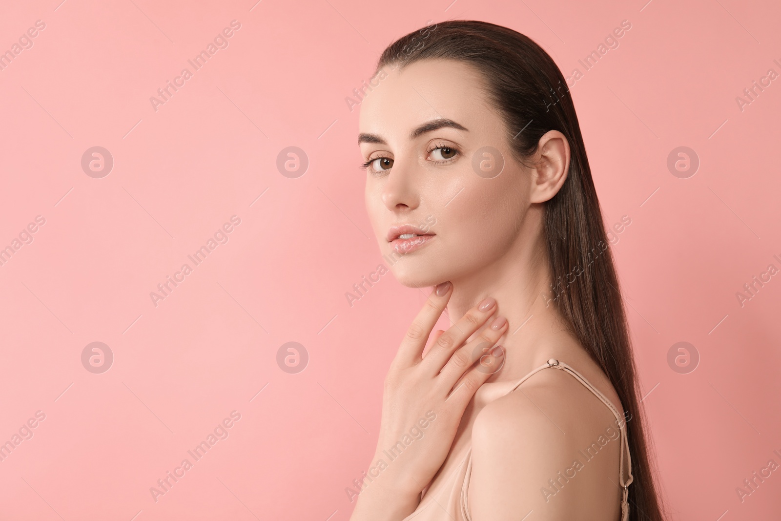 Photo of Portrait of beautiful young woman on pink background. Space for text