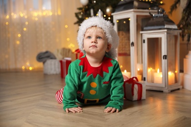 Baby in cute elf costume at home. Christmas outfit