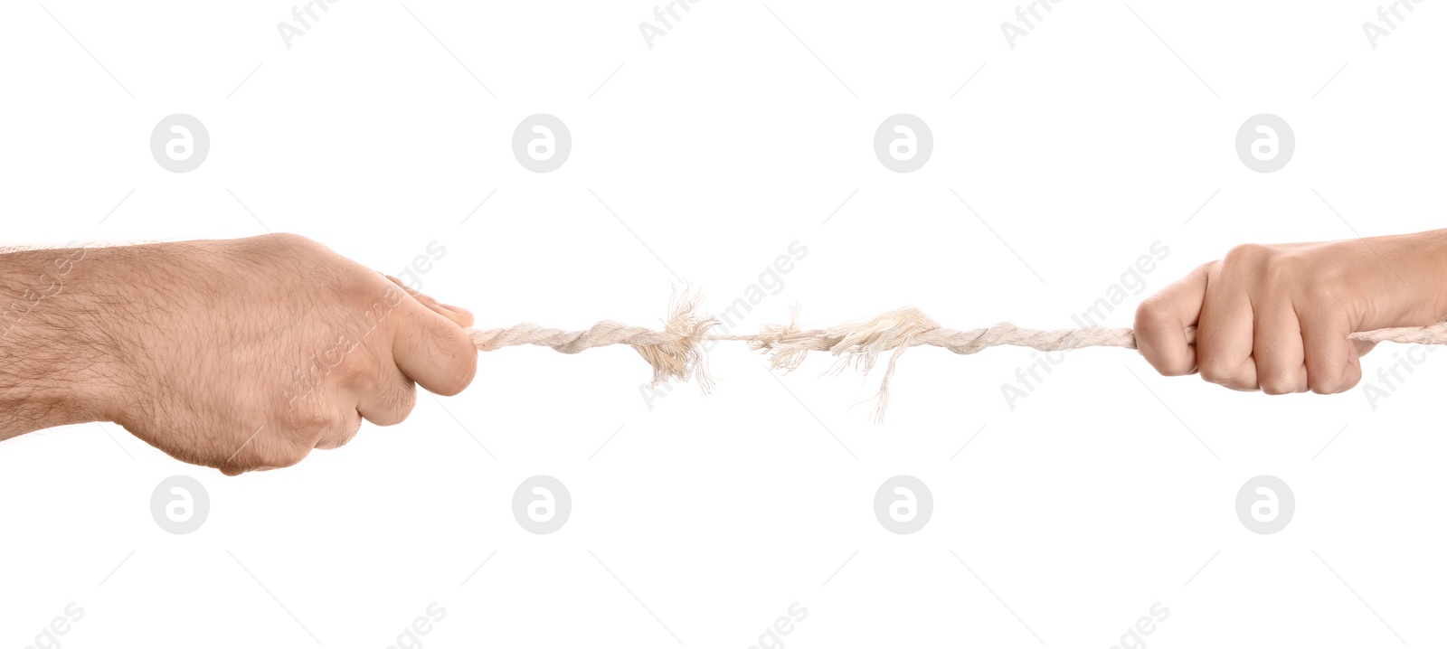 Photo of Man and woman pulling frayed rope at breaking point on white background