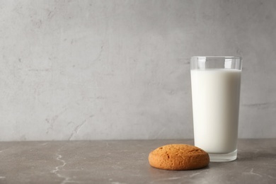 Glass of milk with oatmeal cookie on table. Fresh dairy product