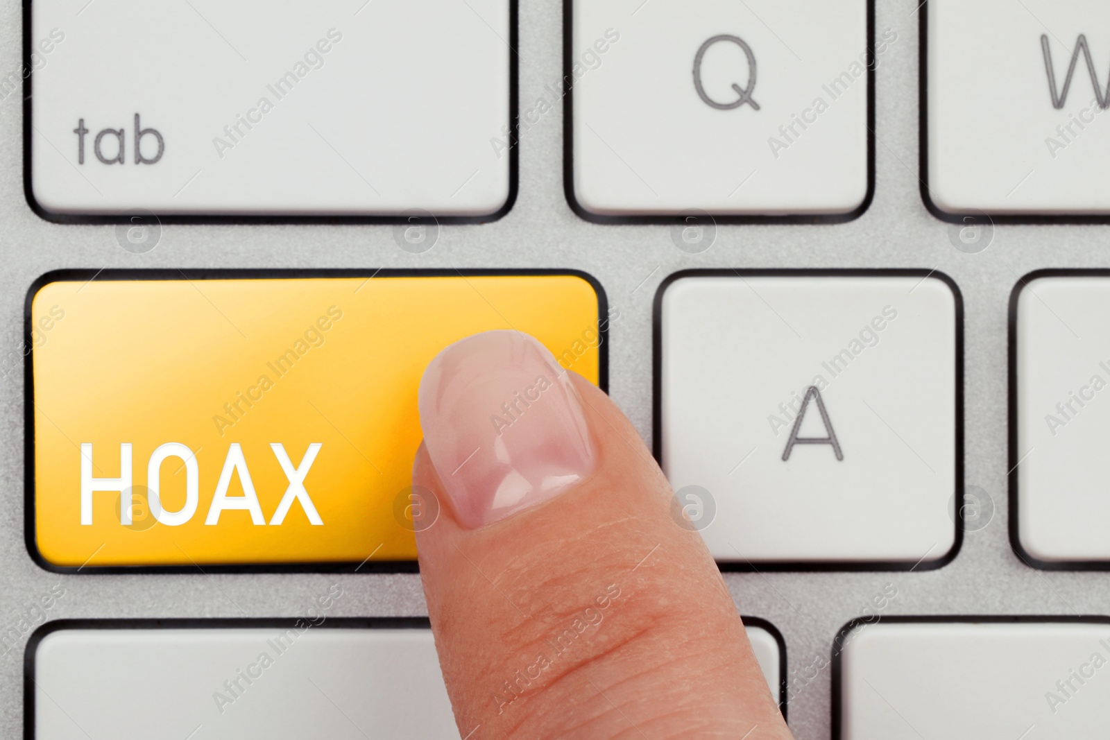 Image of Woman pressing yellow button with word Hoax on computer keyboard, top view