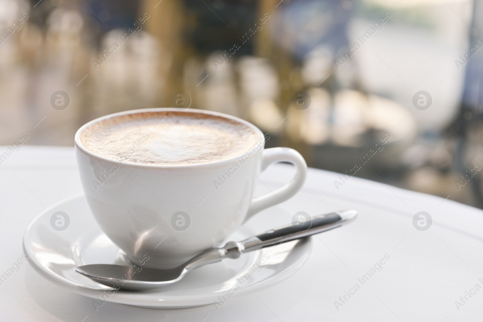 Photo of Cup of fresh coffee on table in morning, space for text