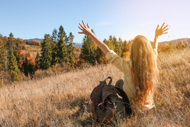 Photo of Female traveler feeling free in peaceful mountains