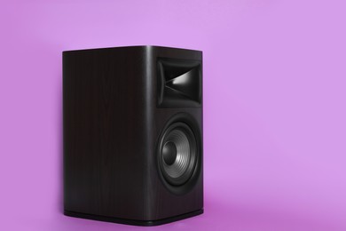 Photo of One wooden sound speaker on violet background. Space for text