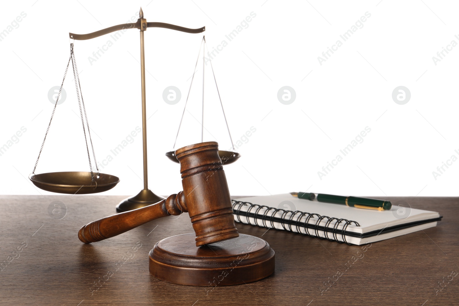 Photo of Law concept. Gavel, scales of justice, notebook and pen on wooden table against white background