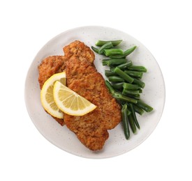 Photo of Plate of tasty schnitzels with lemon and green beans isolated on white, top view
