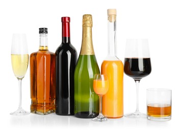 Photo of Bottles and glasses with different alcoholic drinks isolated on white