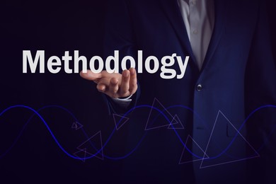 Image of Methodology concept. Man holding virtual word over waves and triangles on dark background, closeup