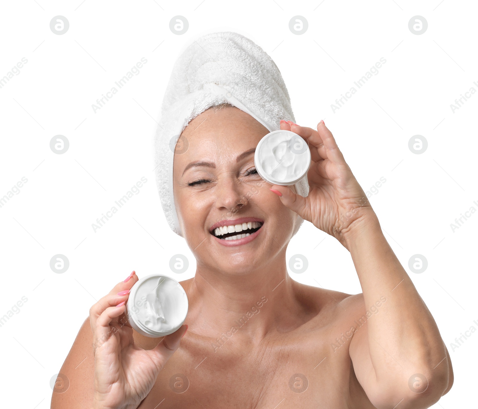 Photo of Portrait of beautiful mature woman with perfect skin holding jars of cream on white background
