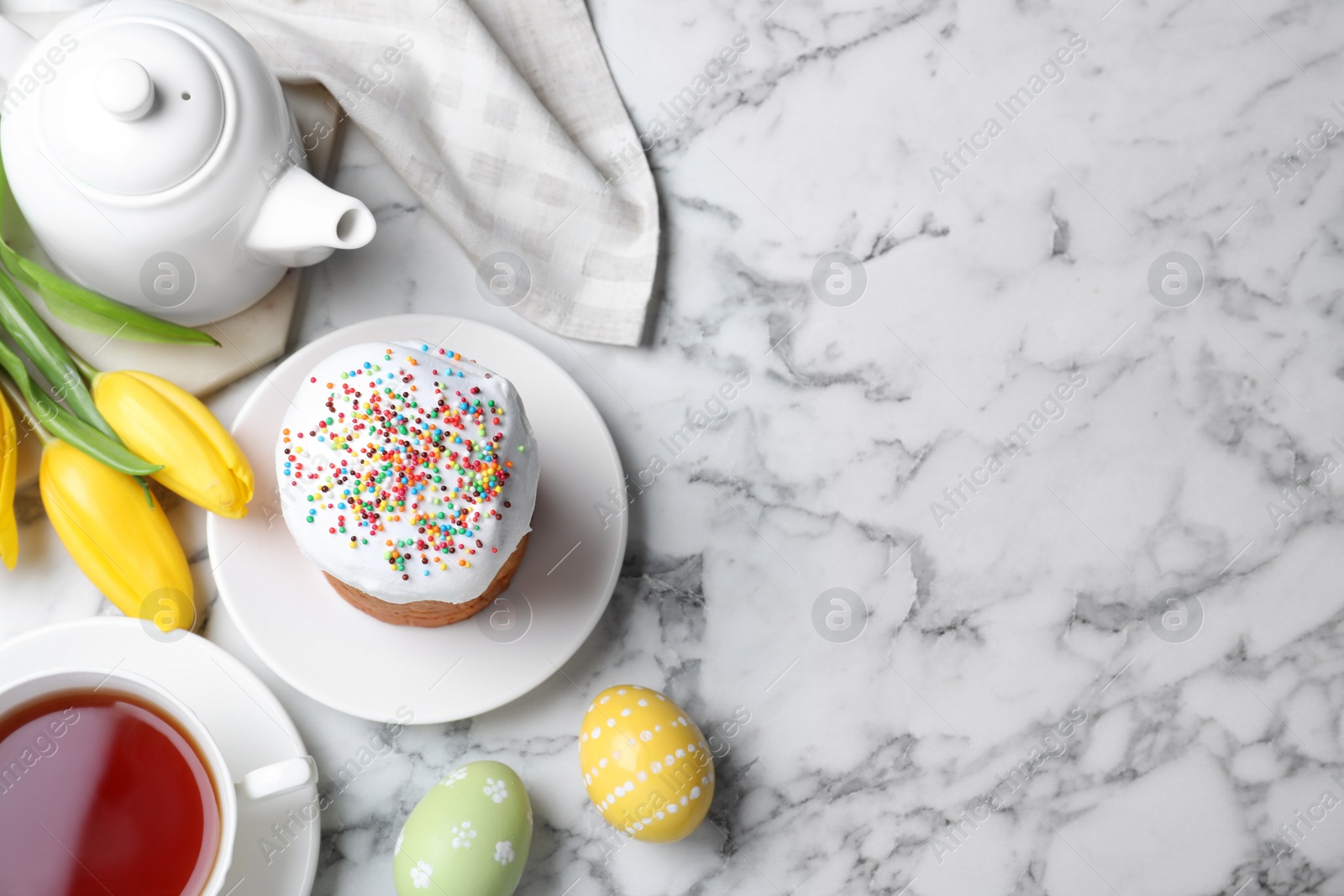 Photo of Flat lay composition with Easter cake on white marble table. Space for text