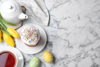 Flat lay composition with Easter cake on white marble table. Space for text