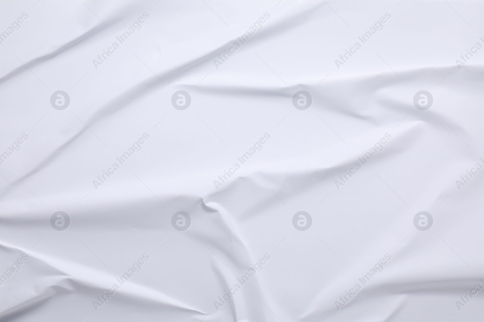 Photo of White crumpled sheet of paper as background, top view. Wall poster