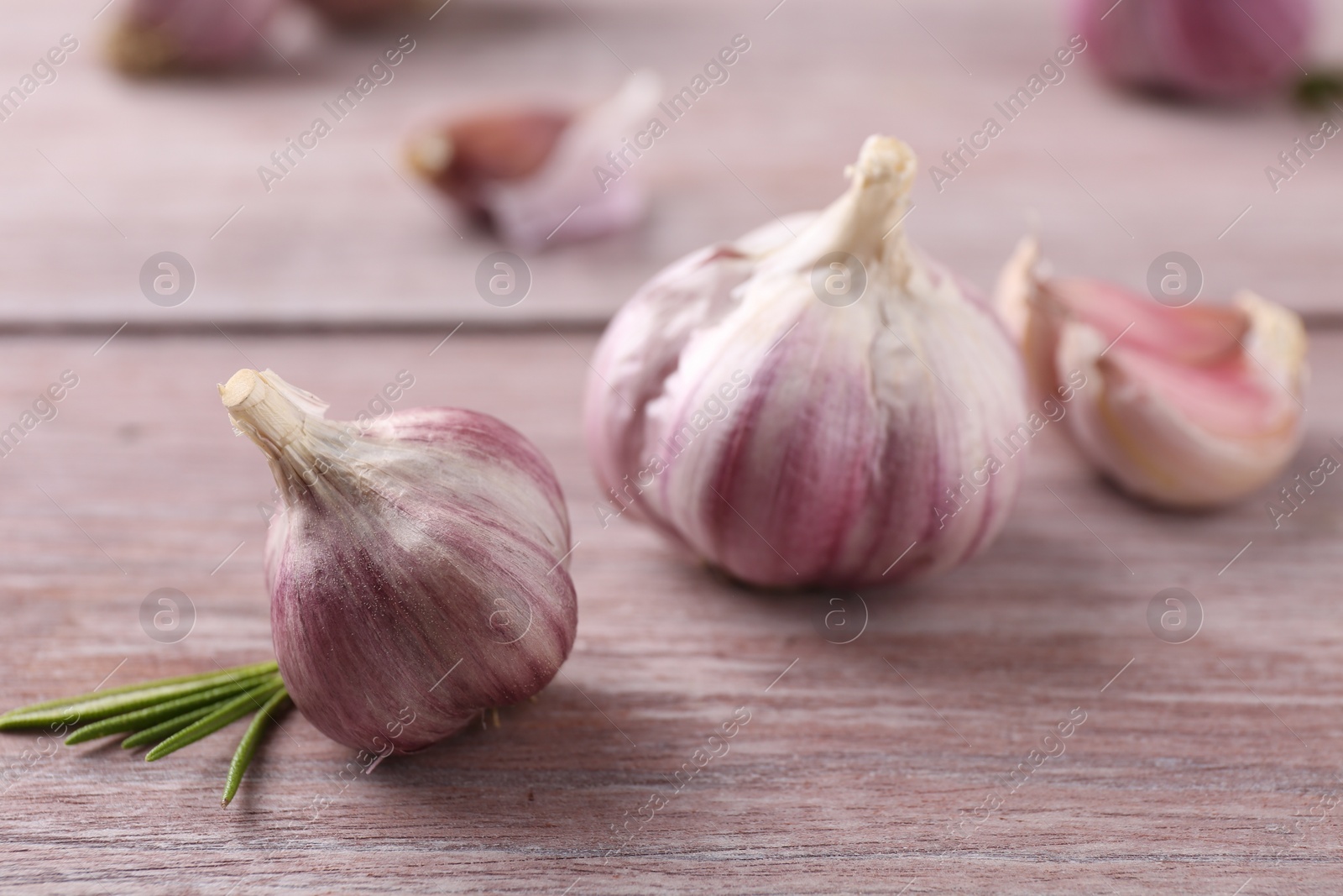 Photo of Bulbs of fresh garlic on wooden table, selective focus