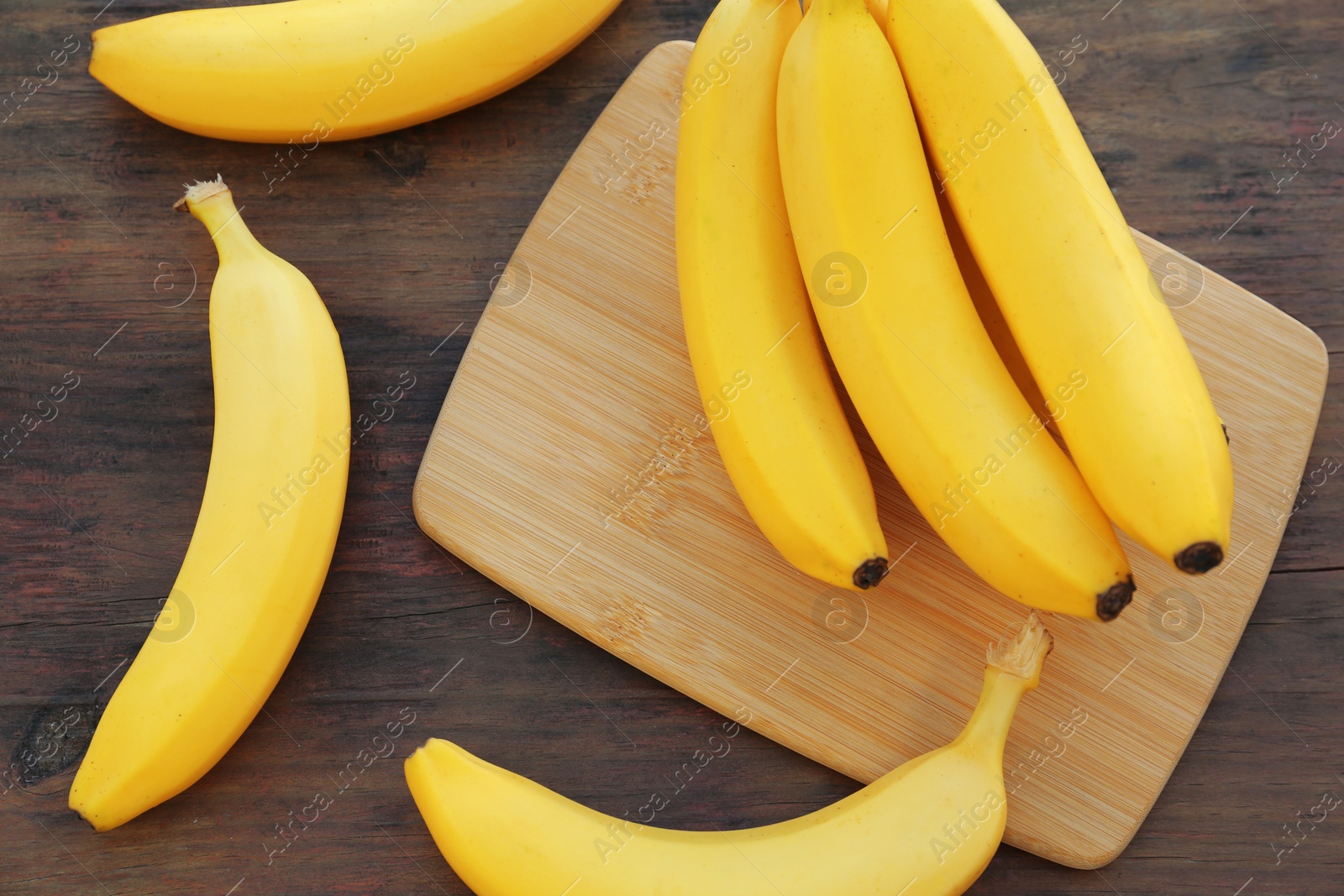 Photo of Delicious bananas on wooden table, flat lay