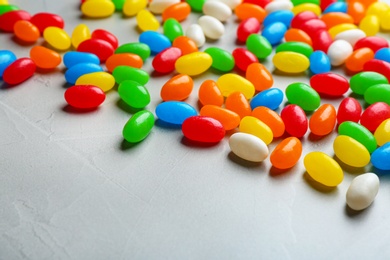 Photo of Colorful sweet jelly beans on grey background