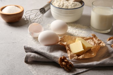 Photo of Different ingredients for dough on light table, closeup