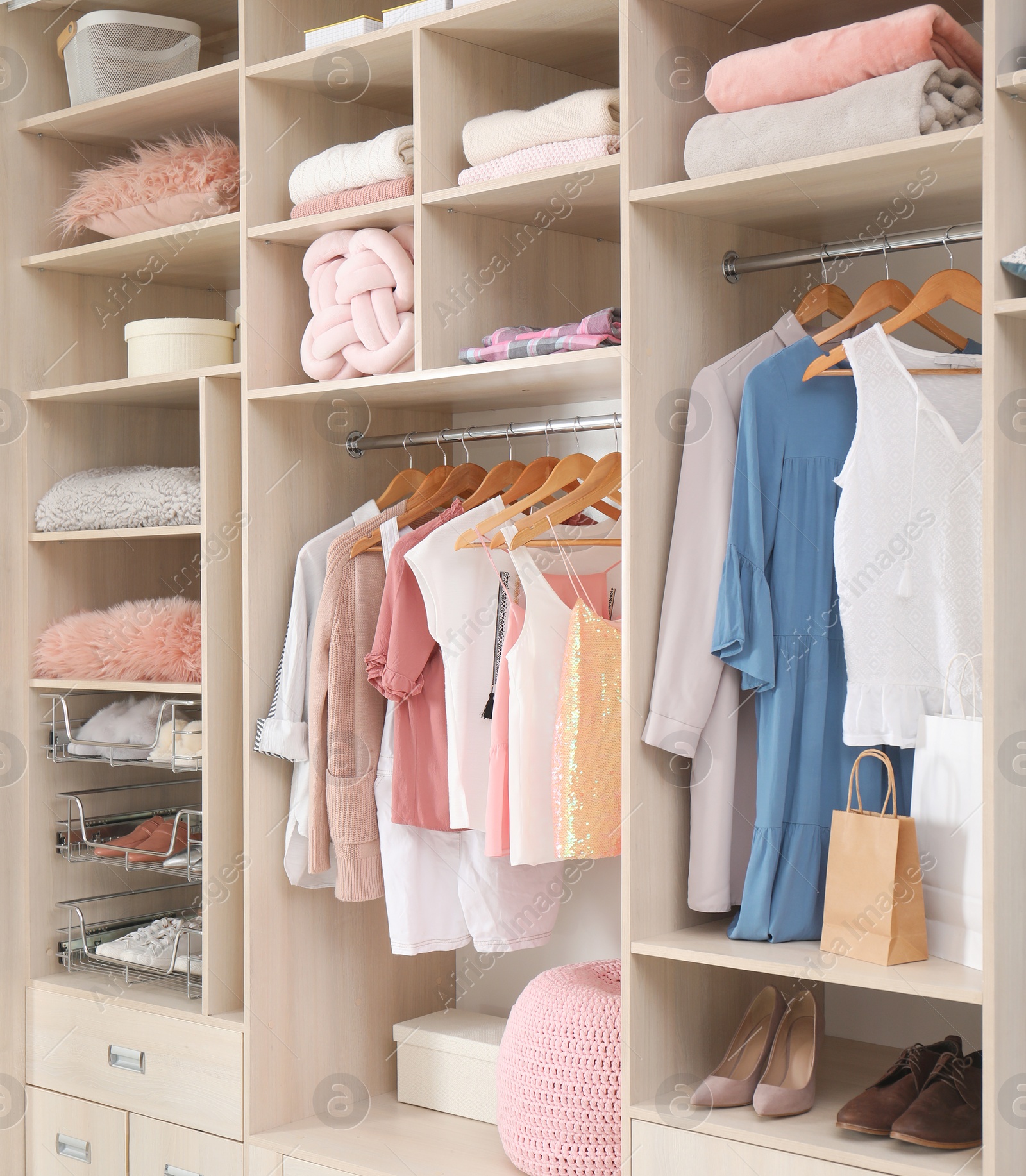 Photo of Stylish clothes, shoes and accessories in large wardrobe closet