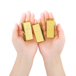 Woman holding shiny gold bars on white background, top view