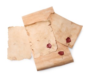 Sheets of old parchment paper with wax stamps on white background, top view