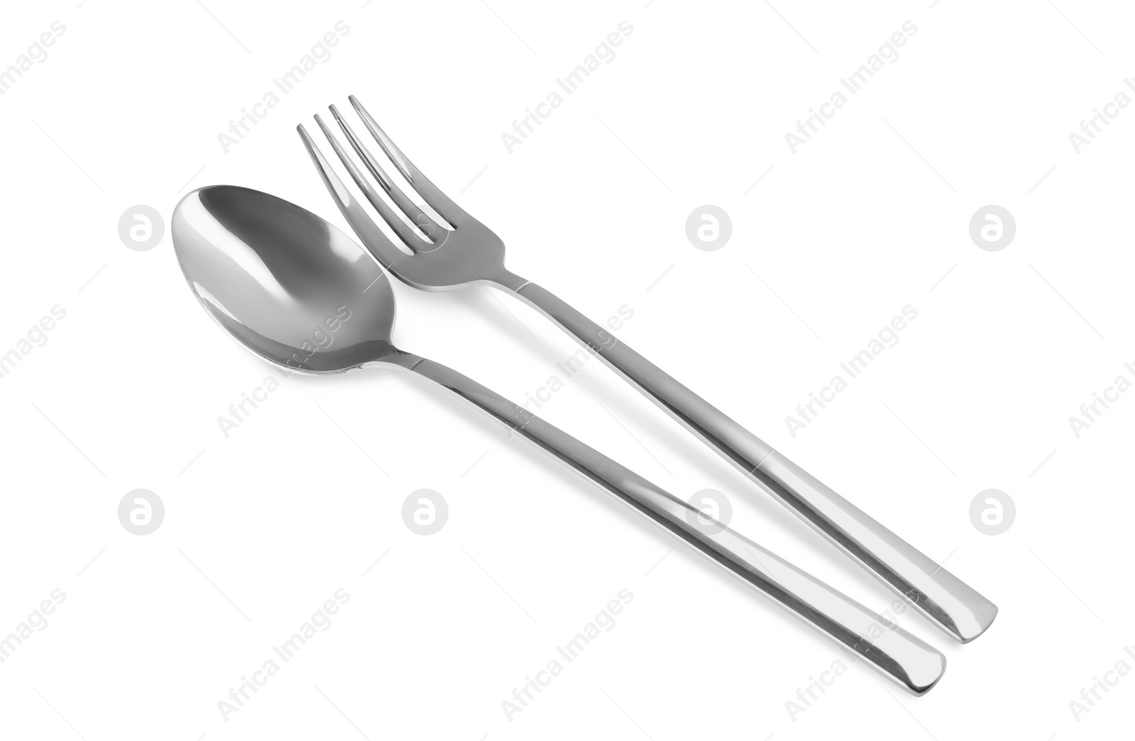 Photo of New shiny fork and spoon on white background