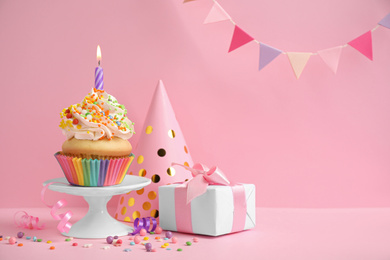 Photo of Composition with birthday cupcake on pink background