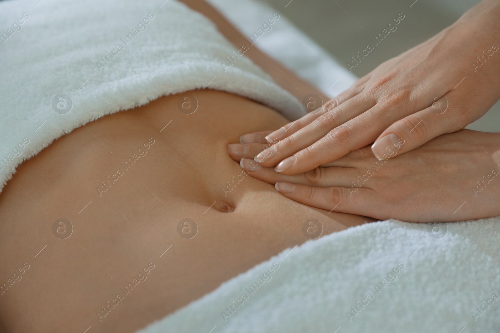 Photo of Woman receiving professional belly massage, closeup view