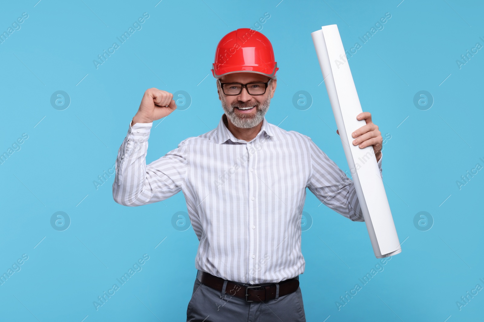 Photo of Architect in hard hat holding draft on light blue background