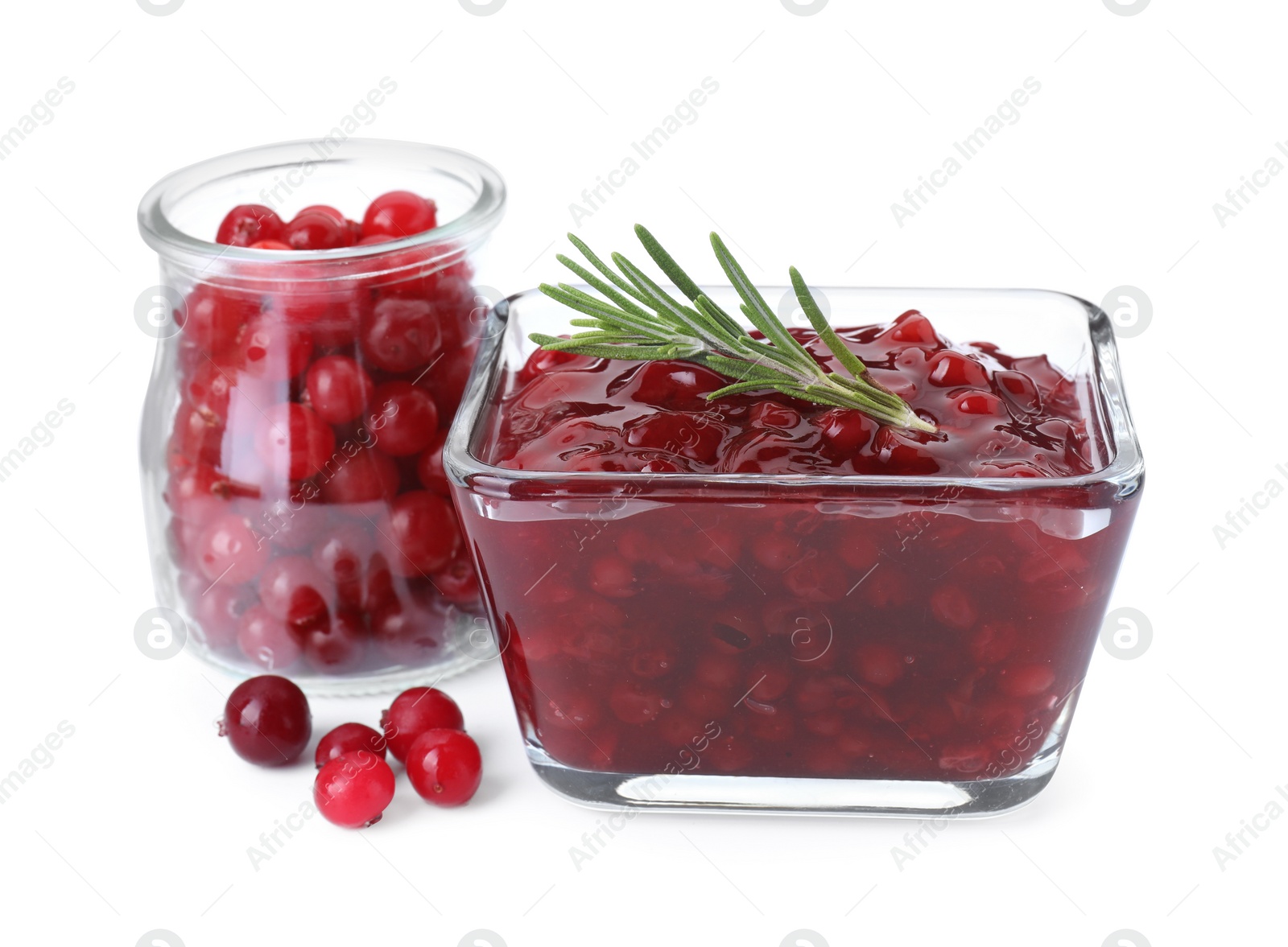 Photo of Tasty cranberry sauce in bowl and glass jar with fresh berries isolated on white