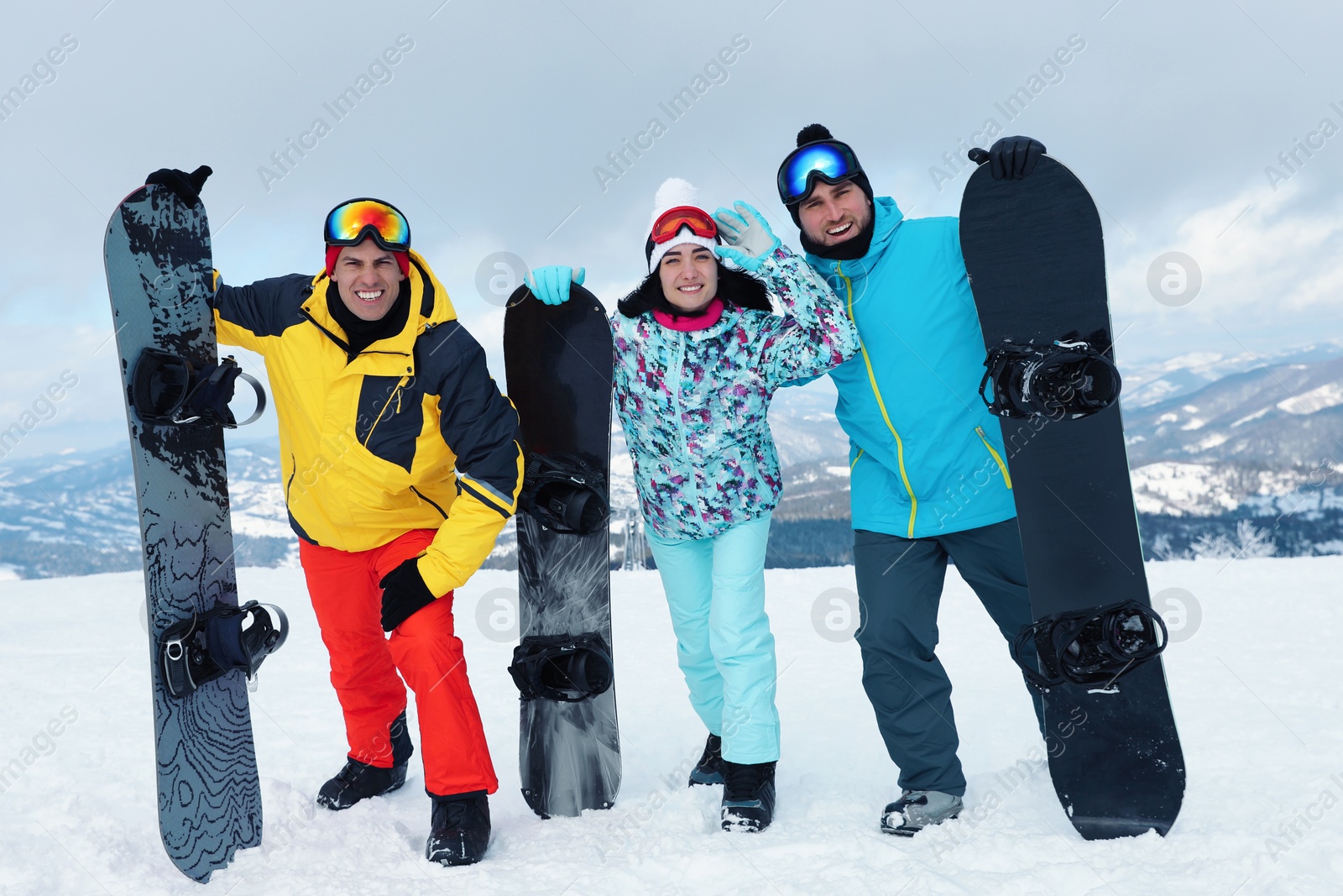 Photo of Group of friends with equipment in snowy mountains. Winter vacation