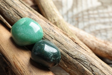 Photo of Beautiful green aventurin and heliotrope gemstones with wooden sticks
