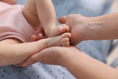 Mother with her cute little baby in crib, closeup