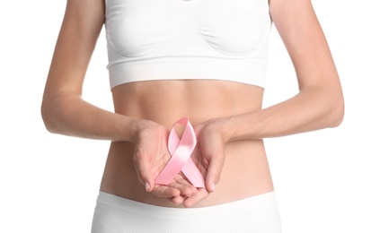 Young woman with symbolic pink ribbon on white background. Breast cancer and gynecology concept