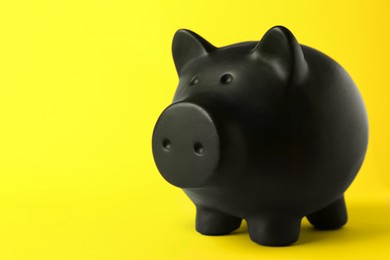 Photo of Ceramic piggy bank on yellow background. Space for text