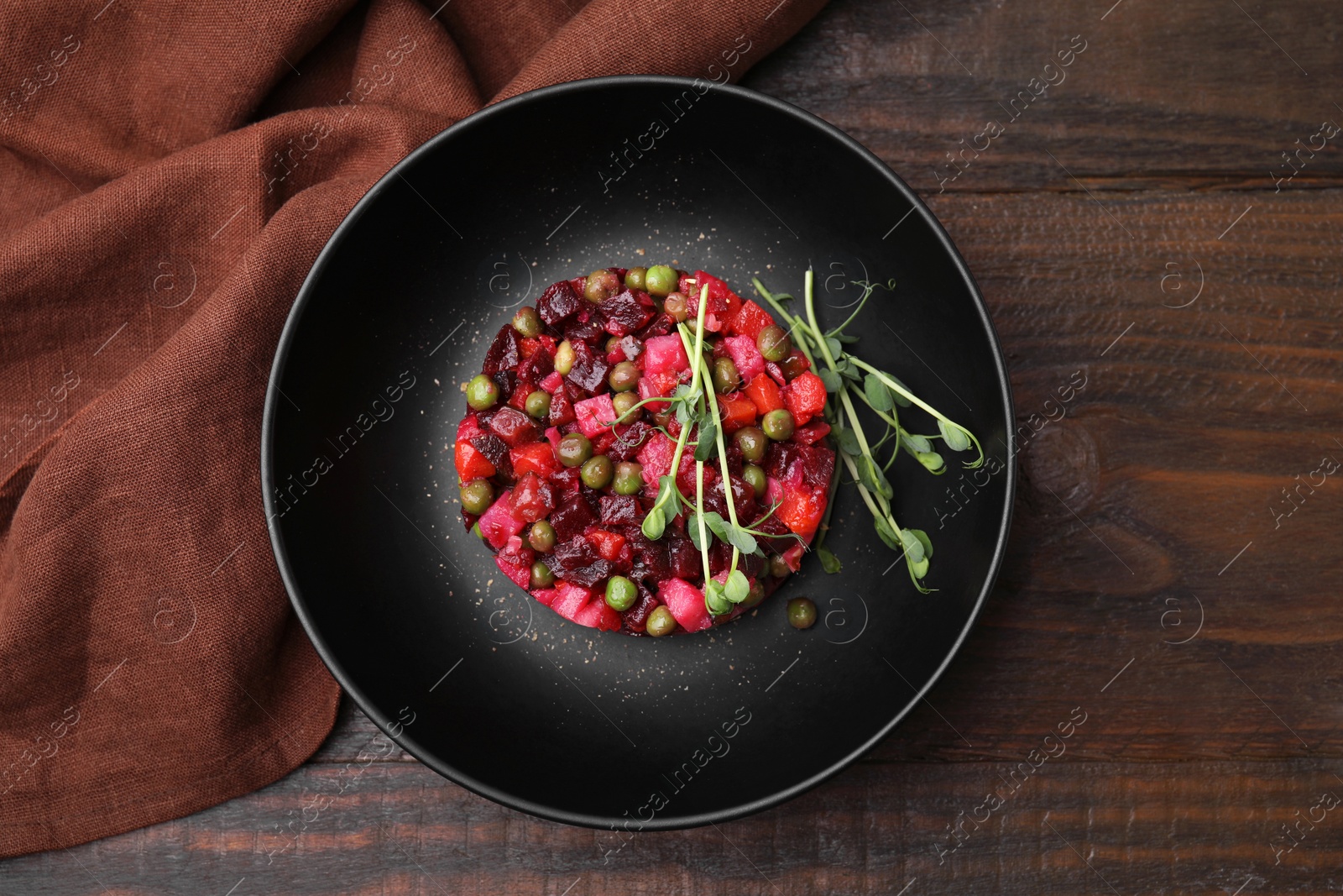 Photo of Delicious vinaigrette salad on wooden table, flat lay