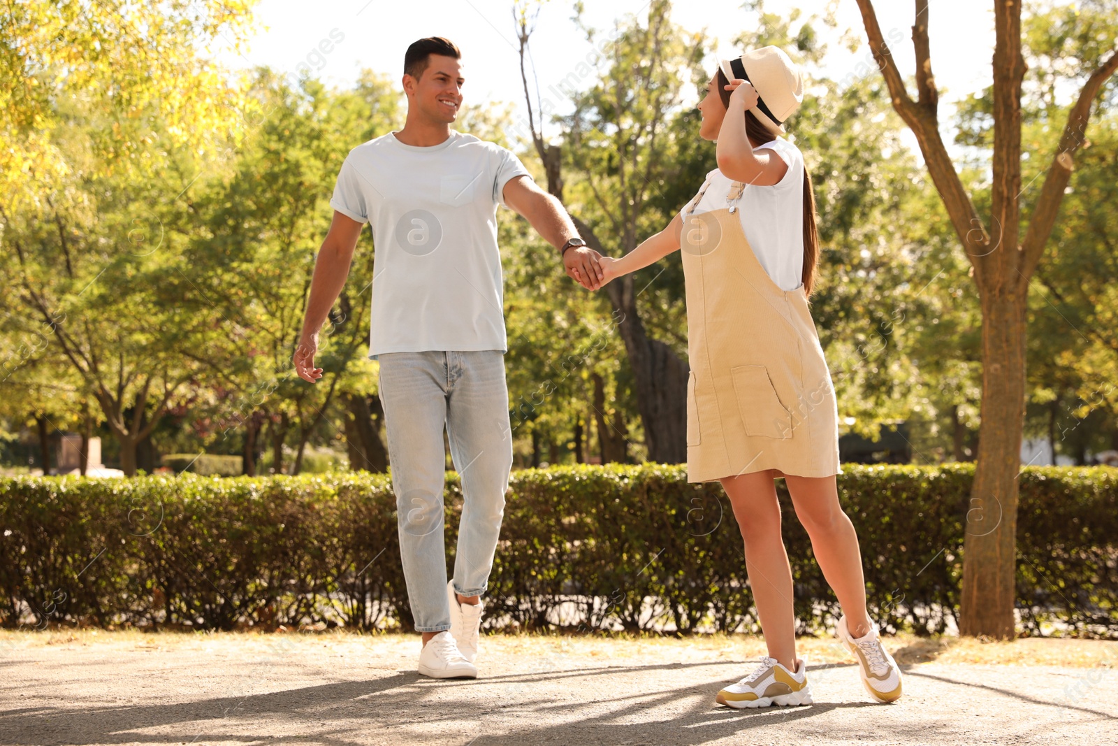 Photo of Lovely couple walking together in park on sunny day